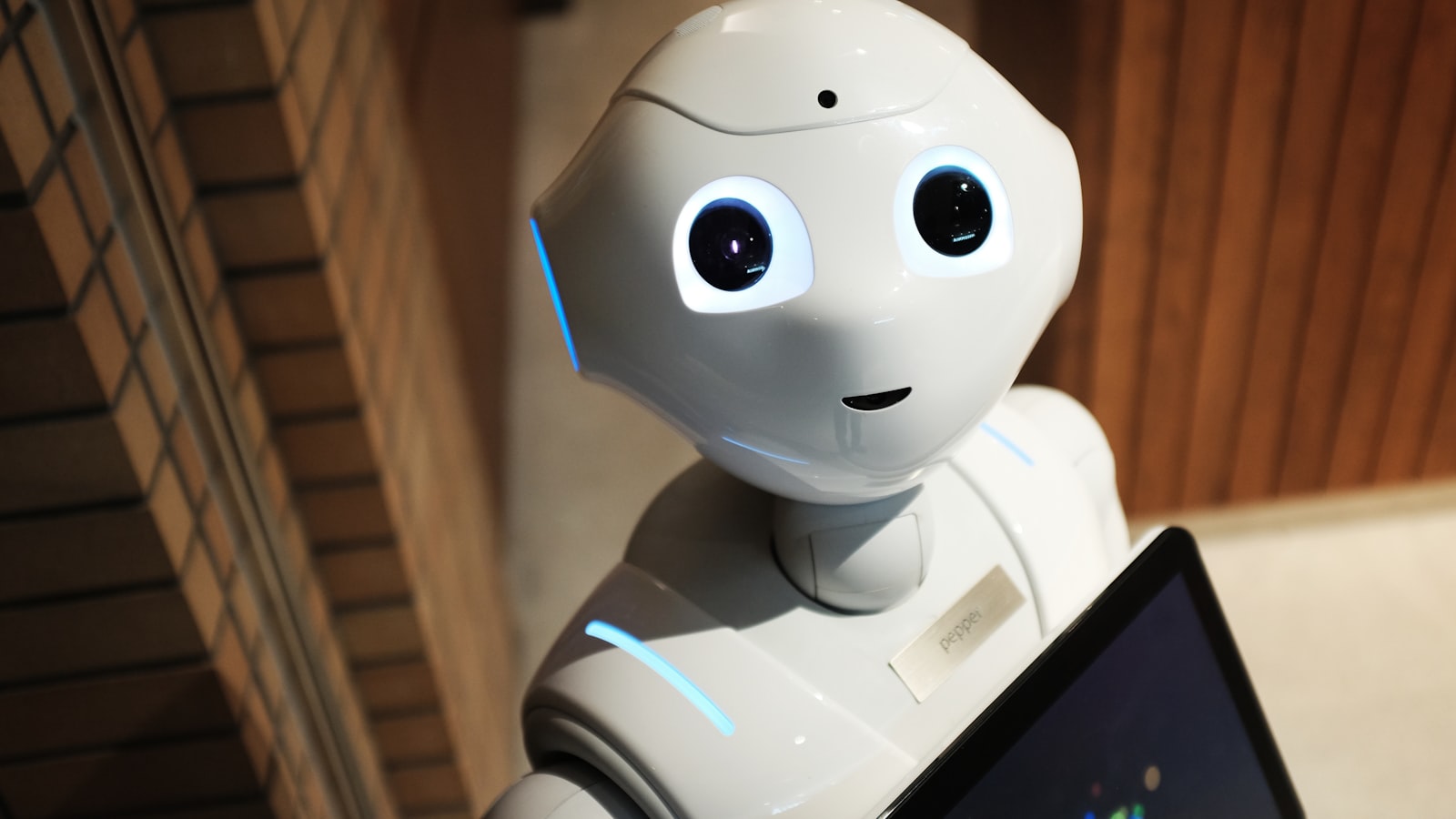 A humanoid robot figure looking thoughtfully toward a bright light source